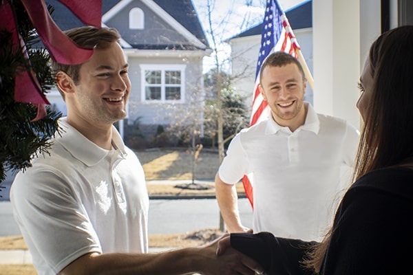 Junk removal professionals greeting a customer