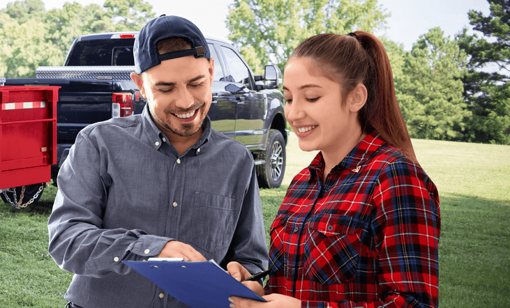 Junk removal professional explaining the junk removal process to happy customer